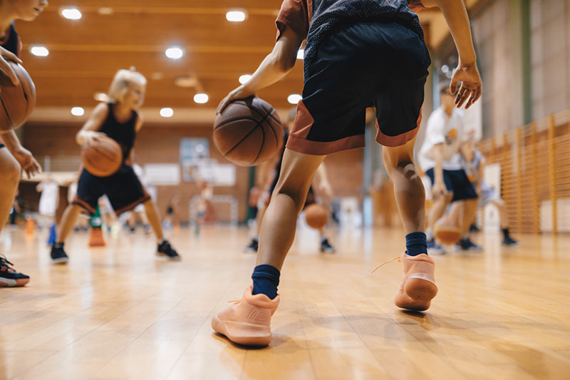 a group of people playing basketball