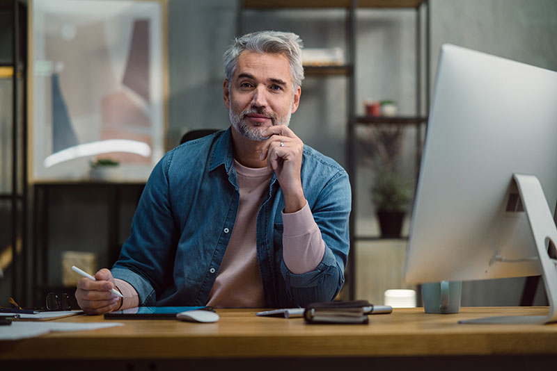 a man sitting at a desk with a computer